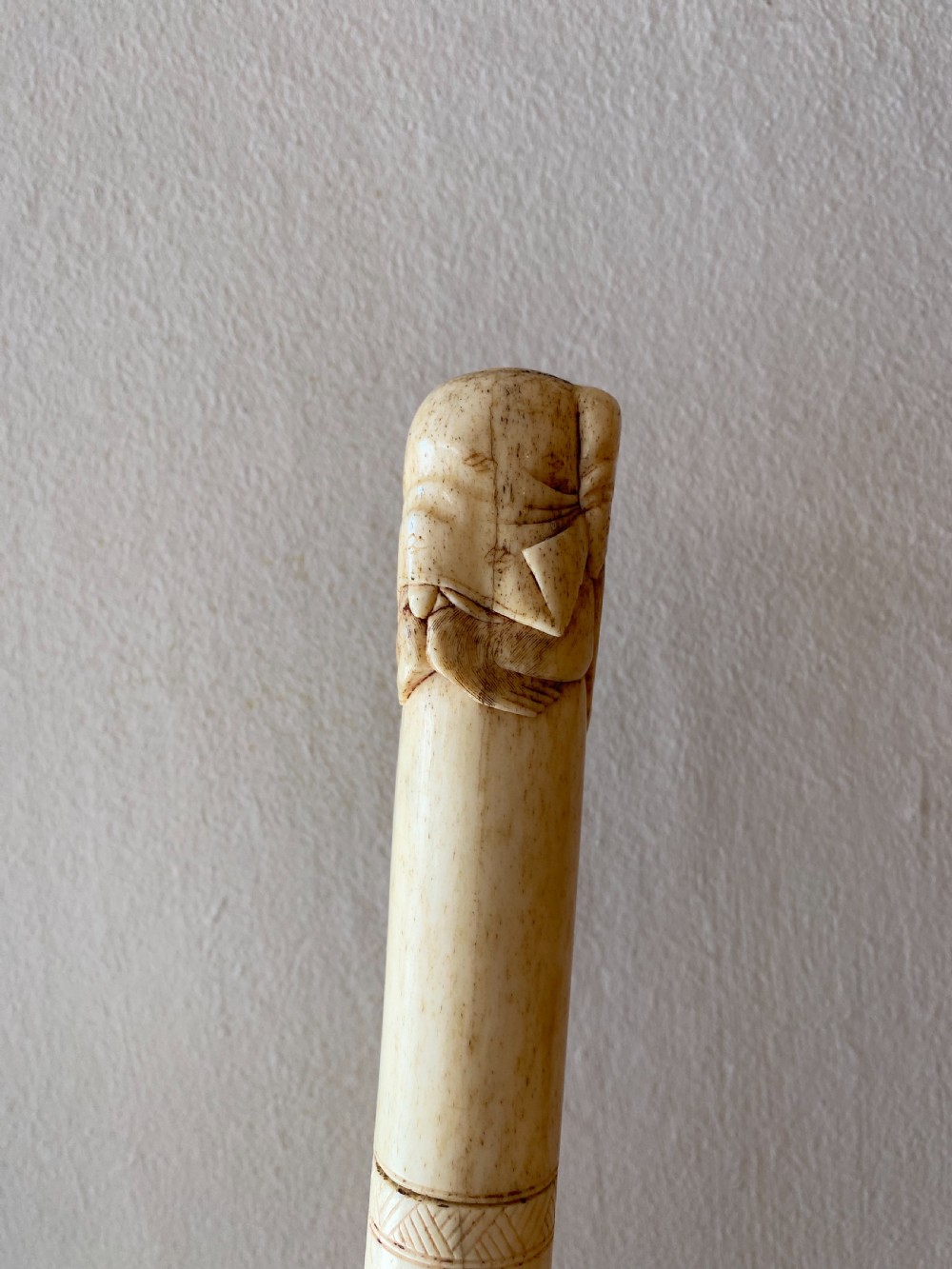 C19th Chinese bone walking stick with carved monkey holding a ball  View II