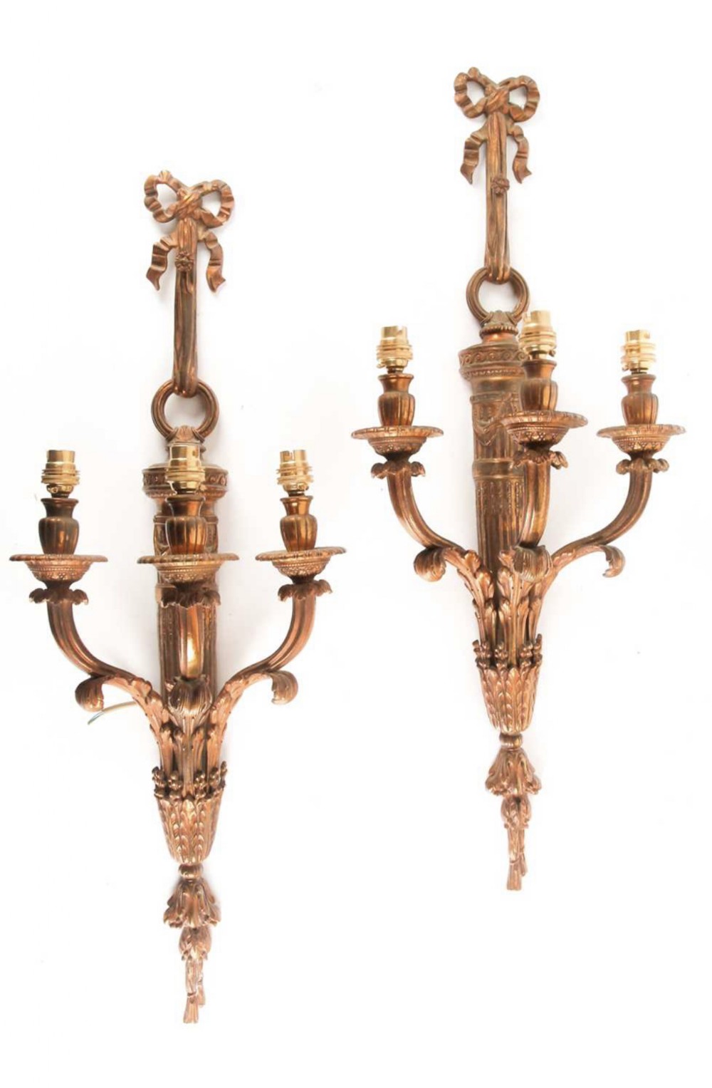 A pair of french empire three branch wall lights 