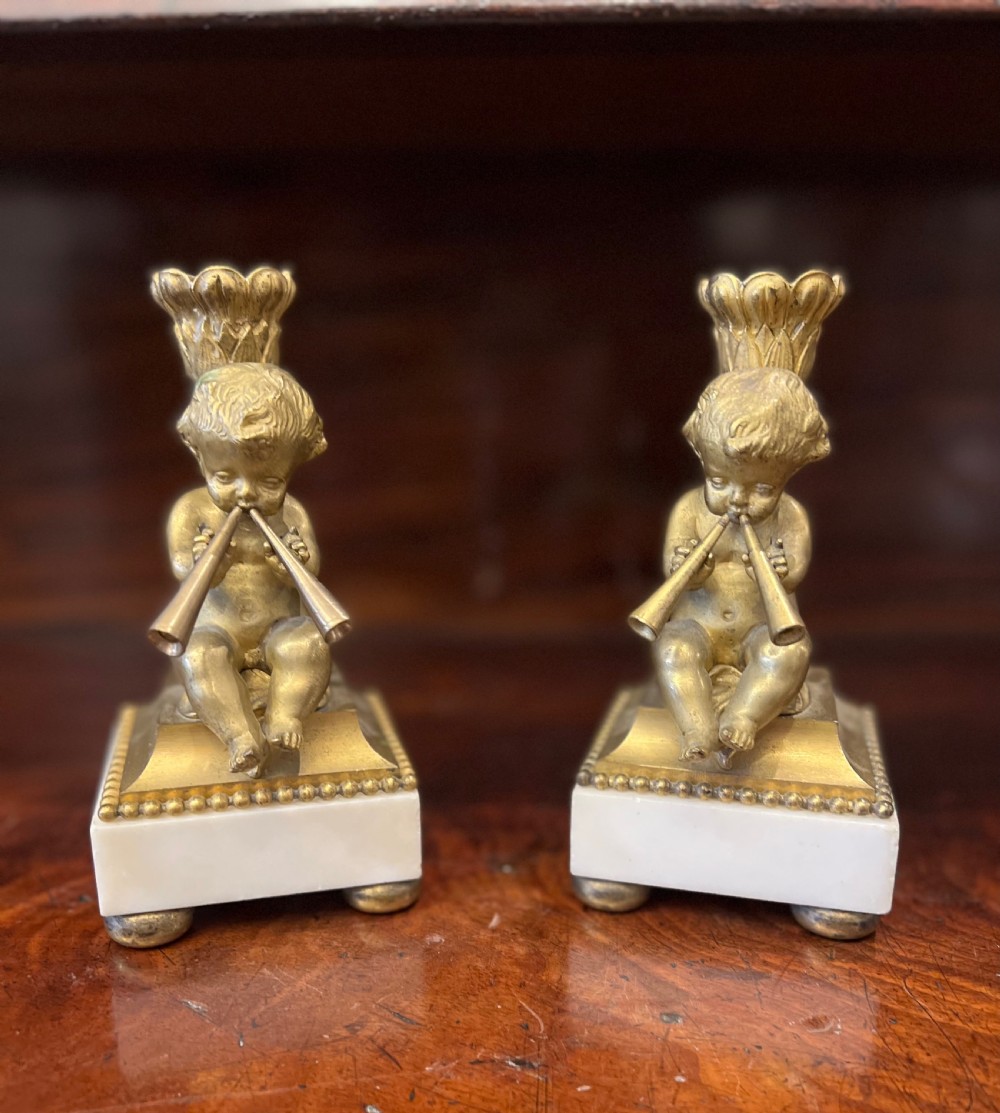 Pair of bronze ormolu cherub candlesticks 