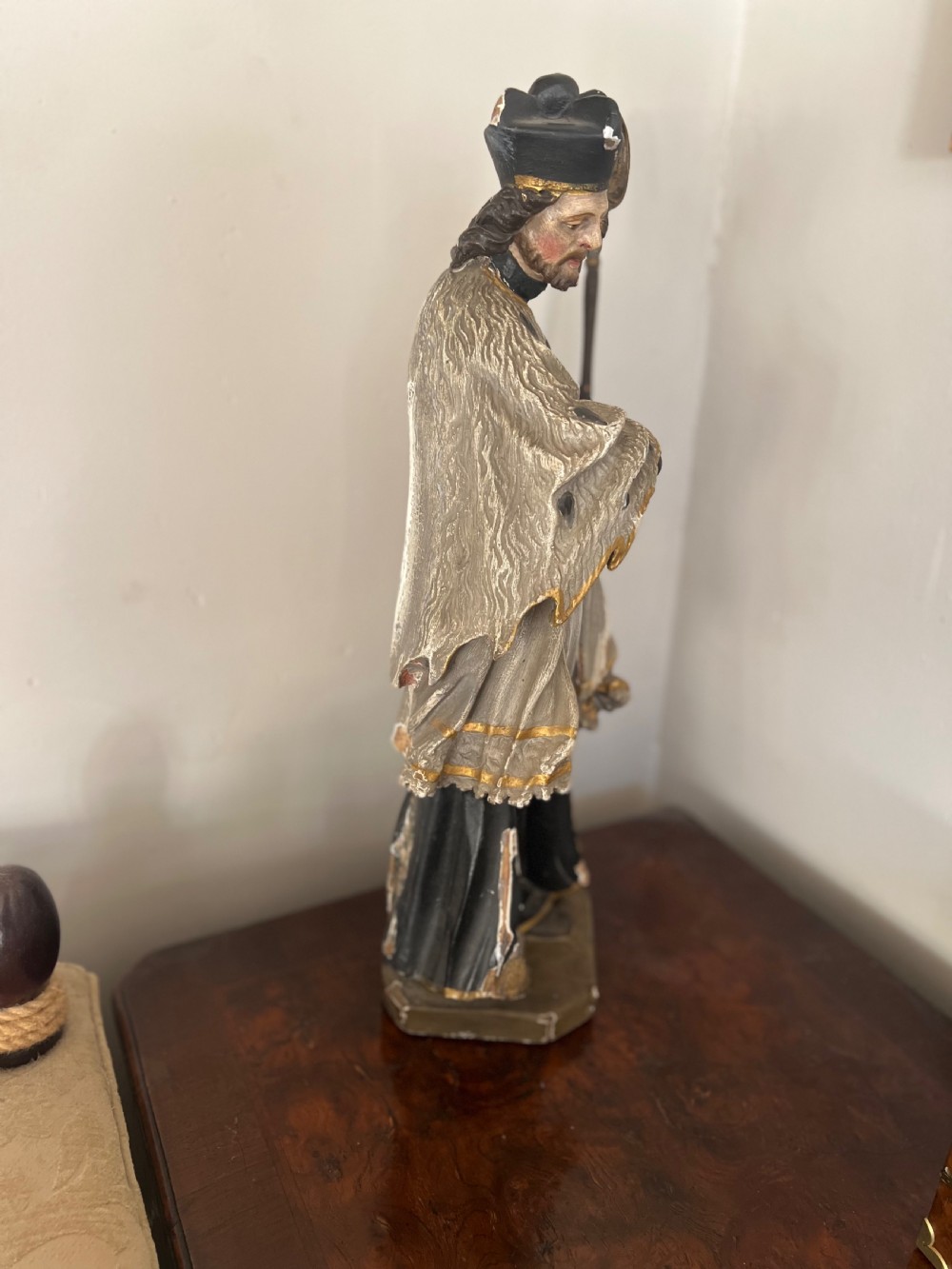 An 18th-century German carved polychrome wood figure depicting Saint John Nepomuk holding a crosier. View V