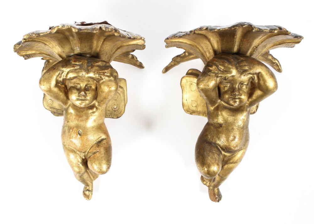 A pair of giltwood cherub wall sconces 