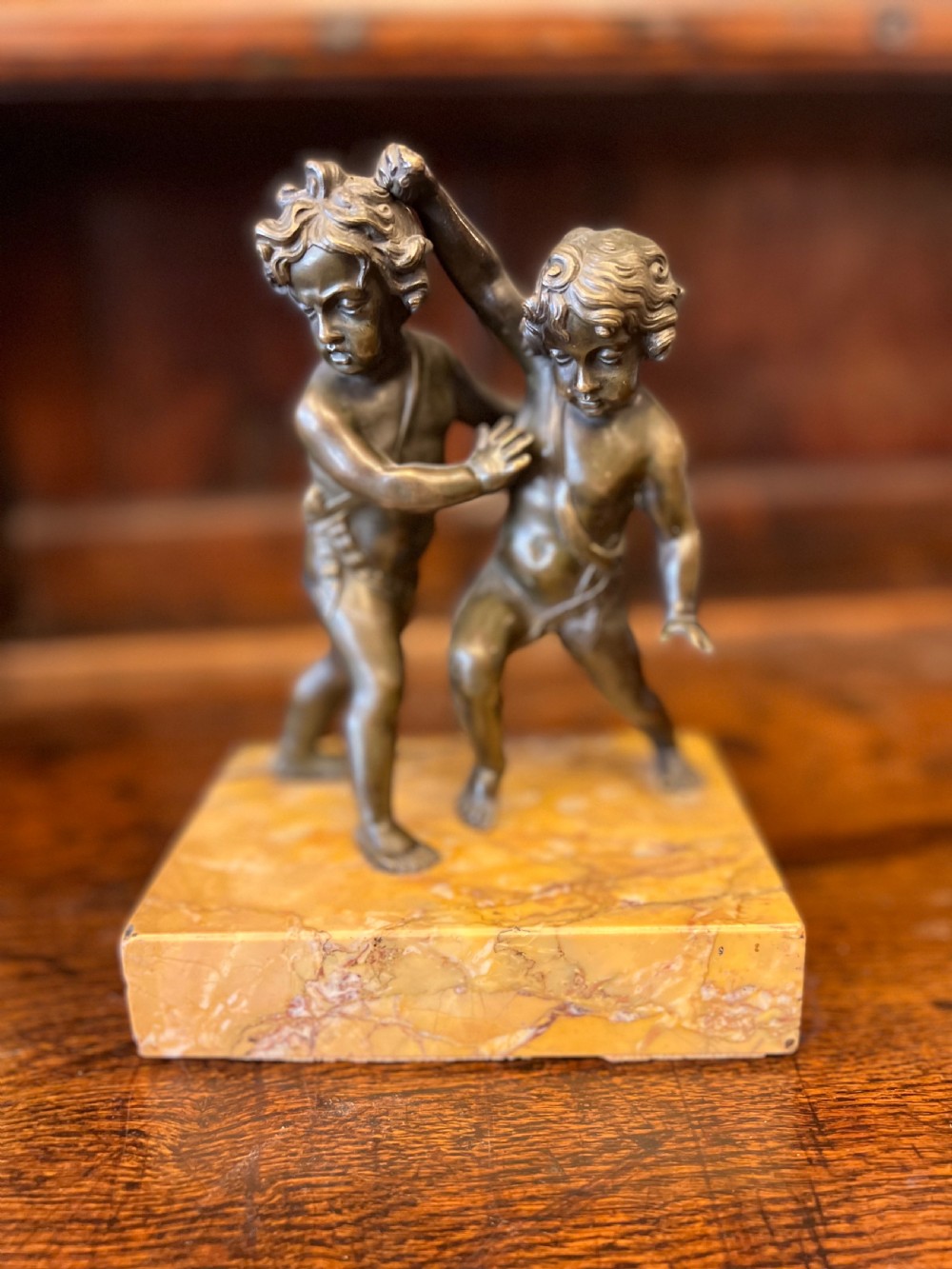 Bronze group of fighting cherubs on sienna marble base  View III