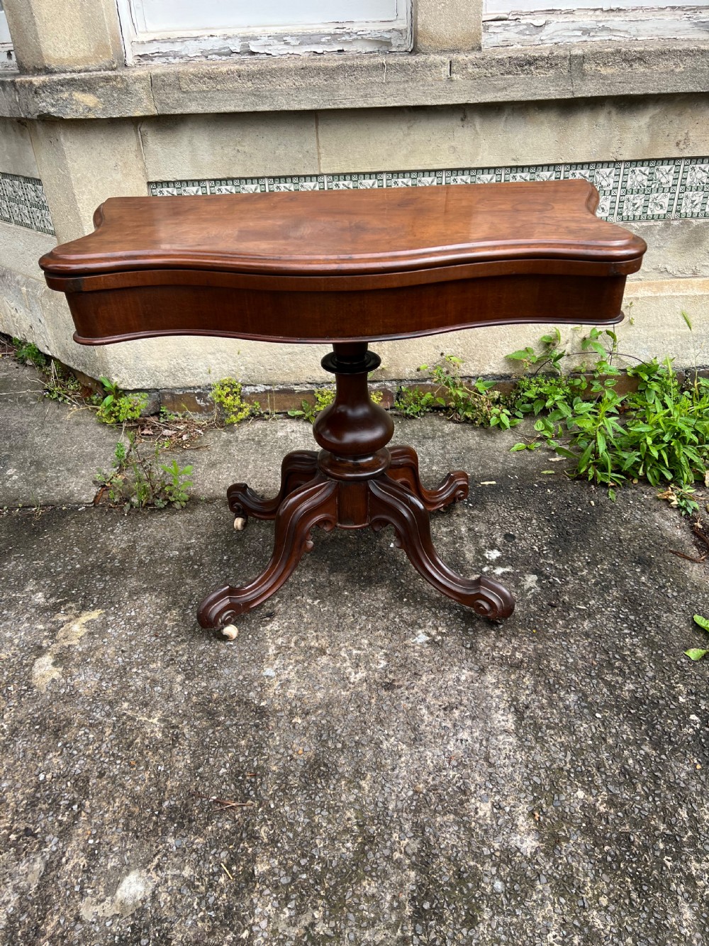 C19th serpentine mahogany pedestal card table  View II