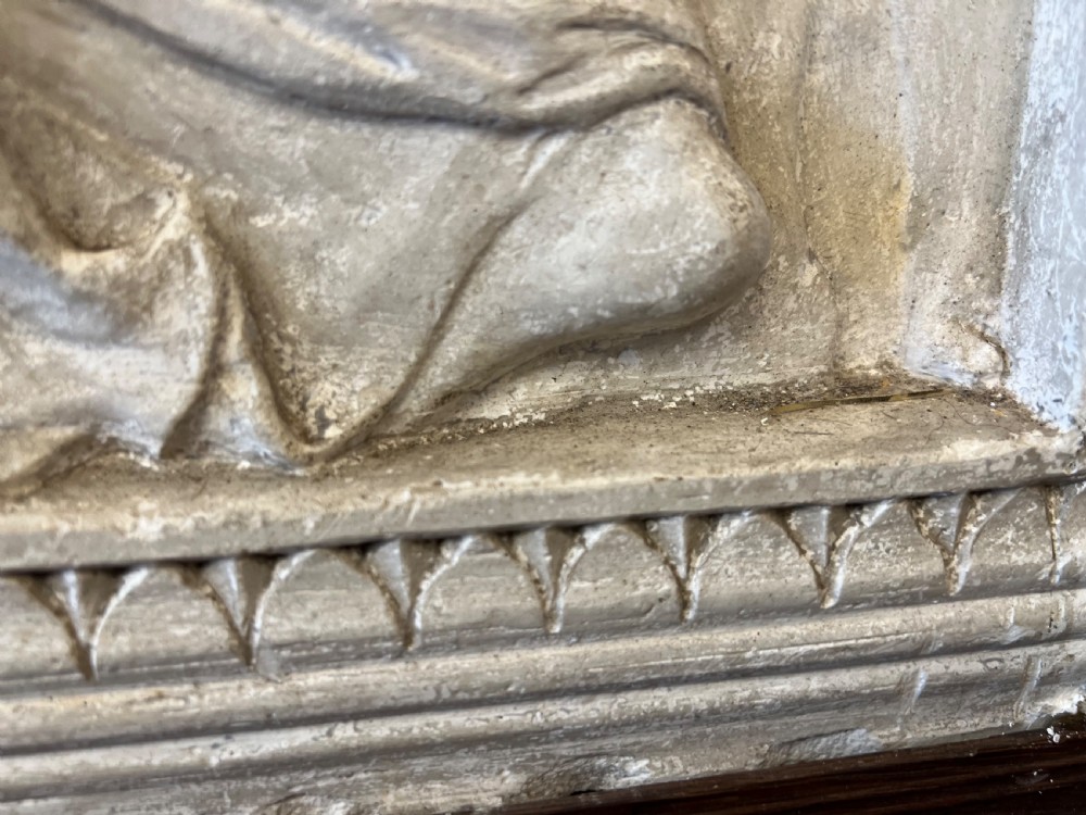 An off-white 19th-century plaster bas-relief panel depicting Christ supported by angels, framed within an inner egg-and-dart moulding and dark timber outer frame. View XIV