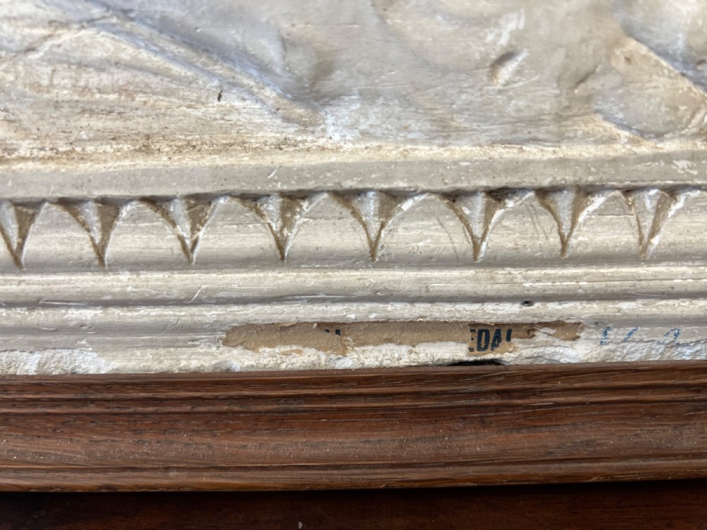 An off-white 19th-century plaster bas-relief panel depicting Christ supported by angels, framed within an inner egg-and-dart moulding and dark timber outer frame. View XV