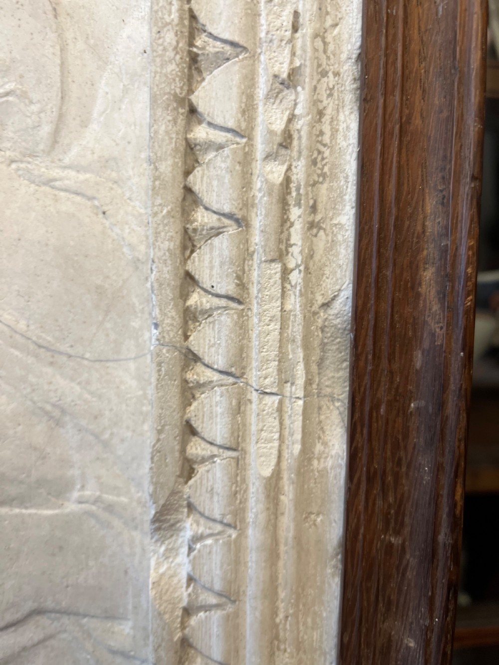 An off-white 19th-century plaster bas-relief panel depicting Christ supported by angels, framed within an inner egg-and-dart moulding and dark timber outer frame. View XVI