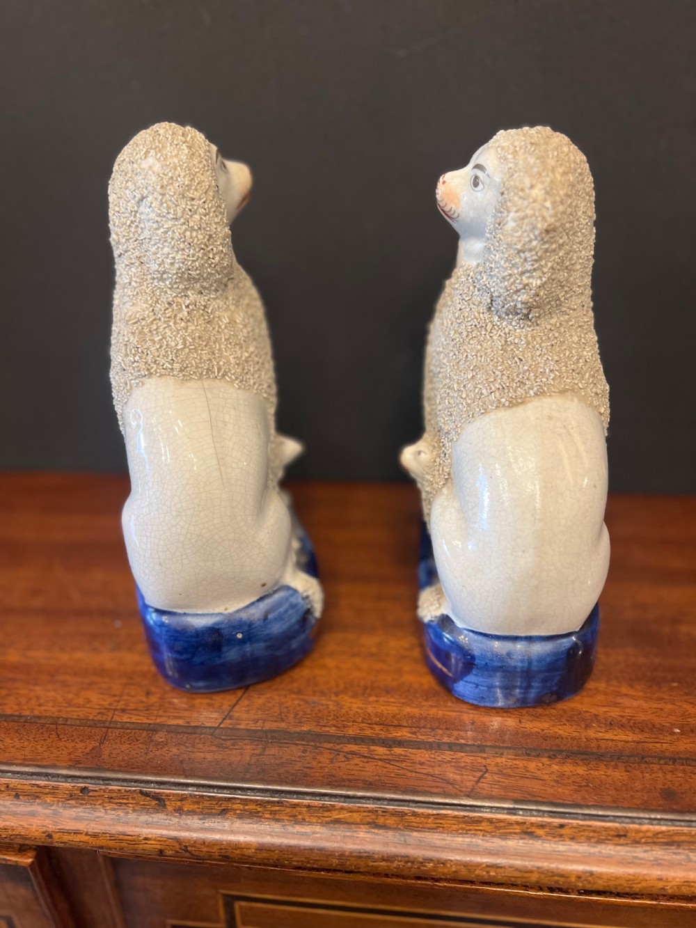 Pair of Staffordshire pottery poodles sat with their puppies  View IV