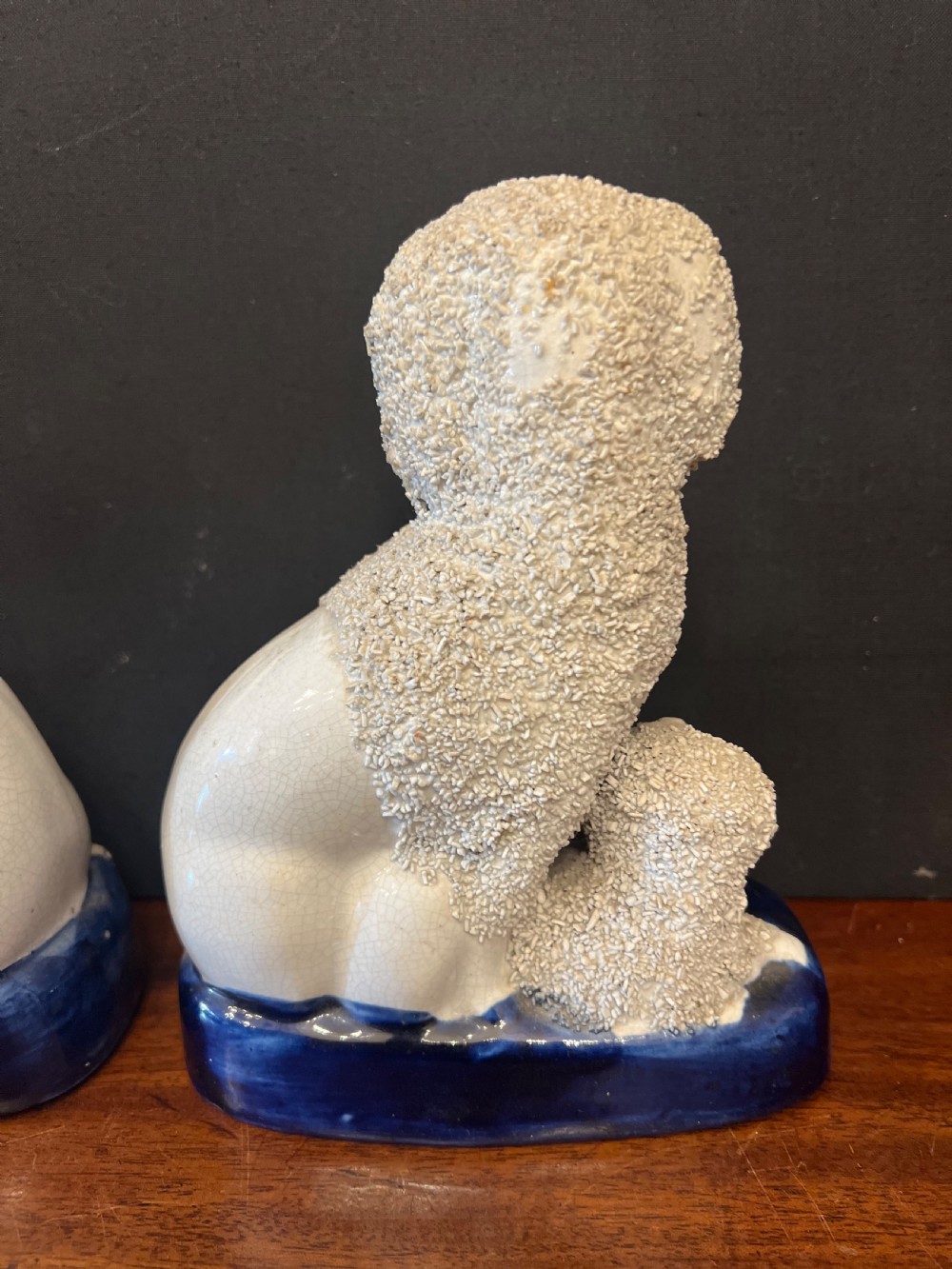 Pair of Staffordshire pottery poodles sat with their puppies  View V