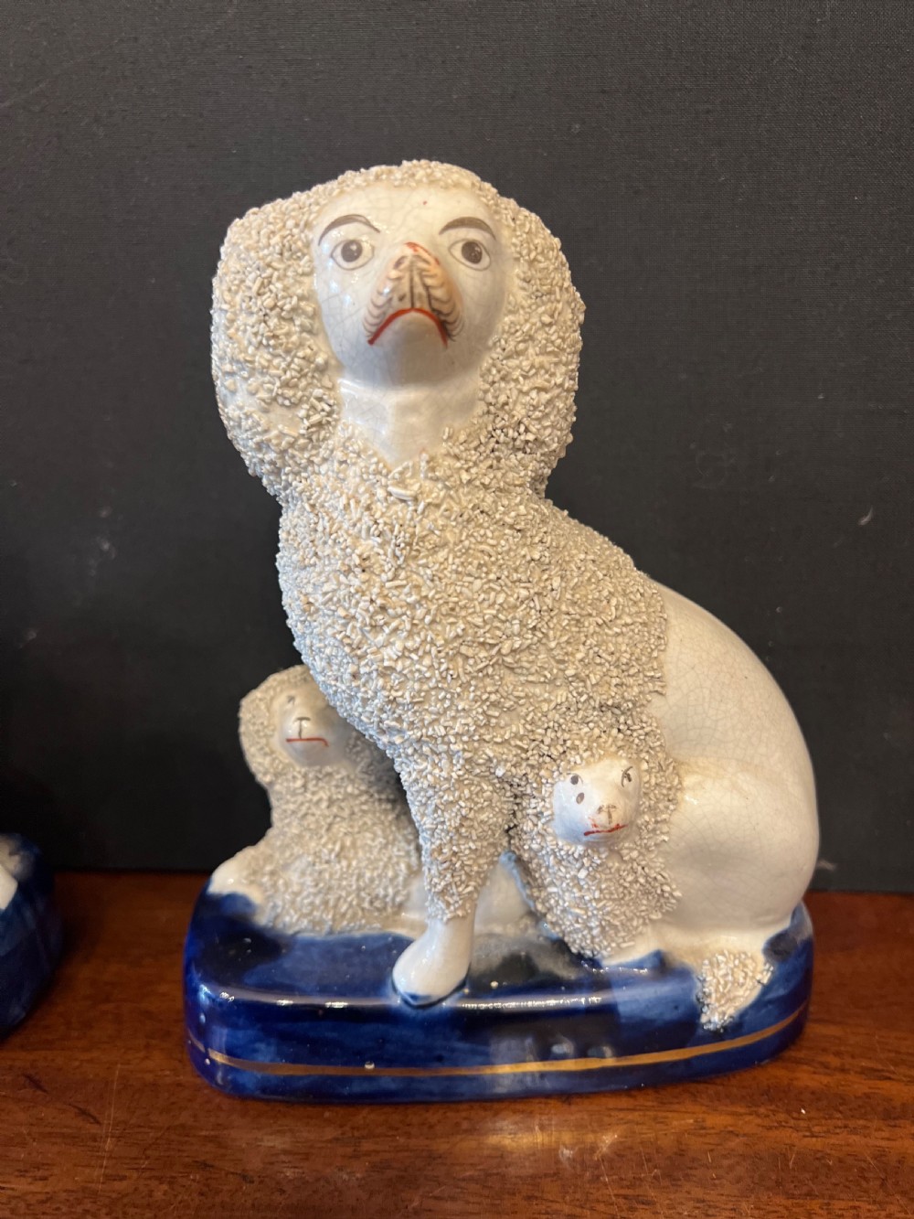 Pair of Staffordshire pottery poodles sat with their puppies  View VII