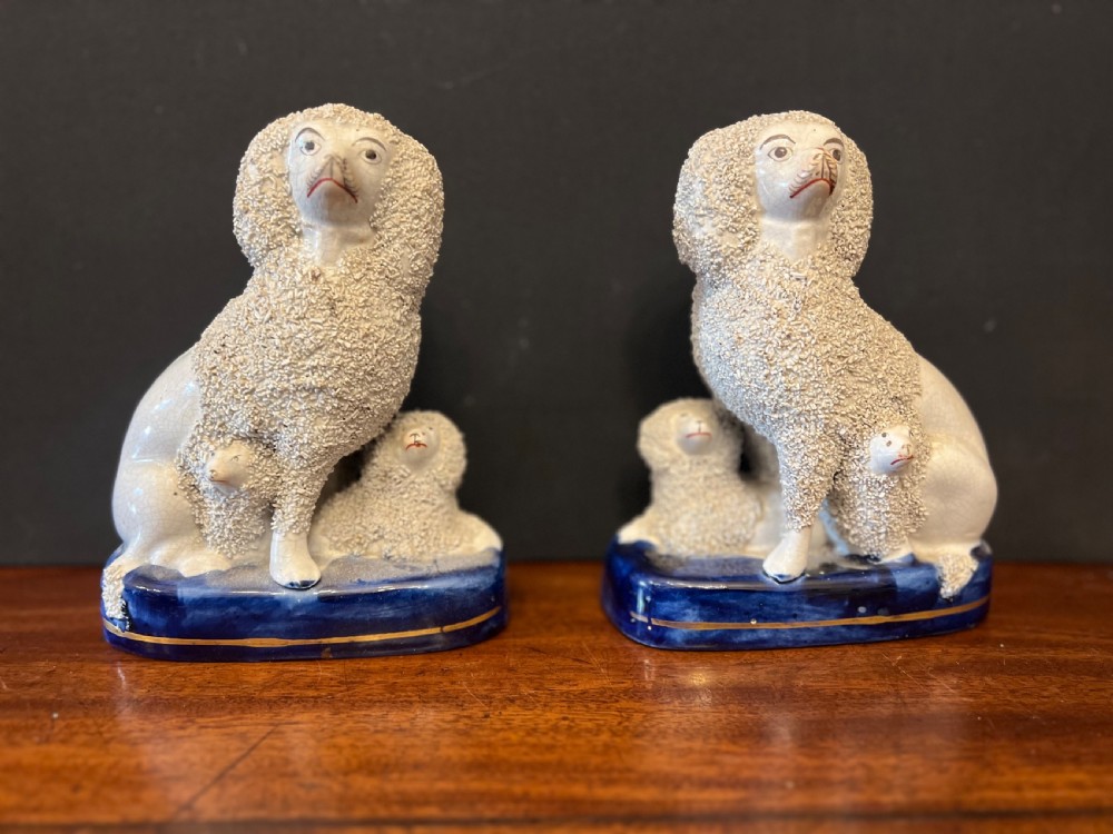 Pair of Staffordshire pottery poodles sat with their puppies  View VIII