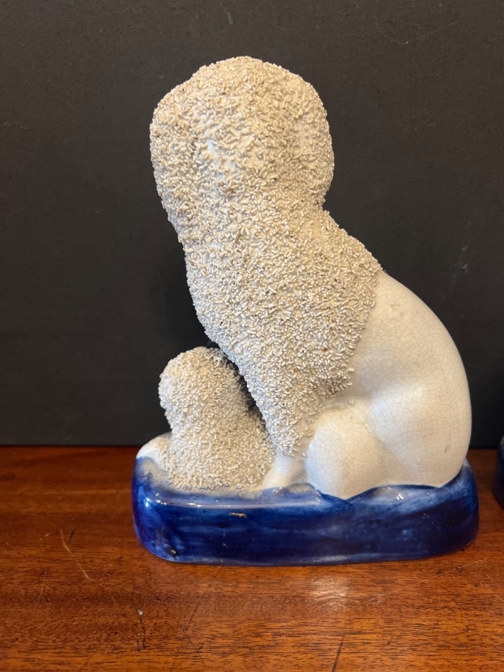 Pair of Staffordshire pottery poodles sat with their puppies  View XI