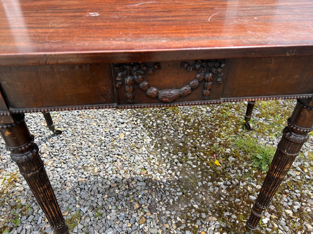 A pair of c1800 D end tables with ribbon swag carving and paterae View XVI