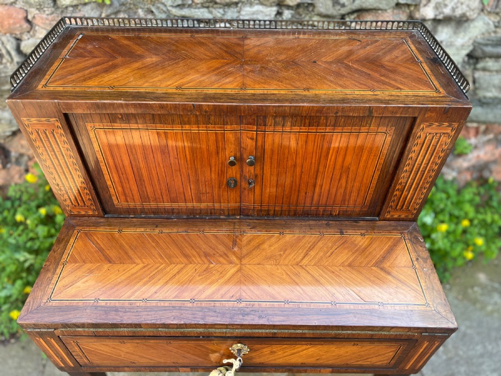 An 18th-century French bonheur de jour desk in warm brown inlaid wood, featuring square tapered legs, a single drawer with a tassel key, and a top cabinet with a pierced brass gallery. View III