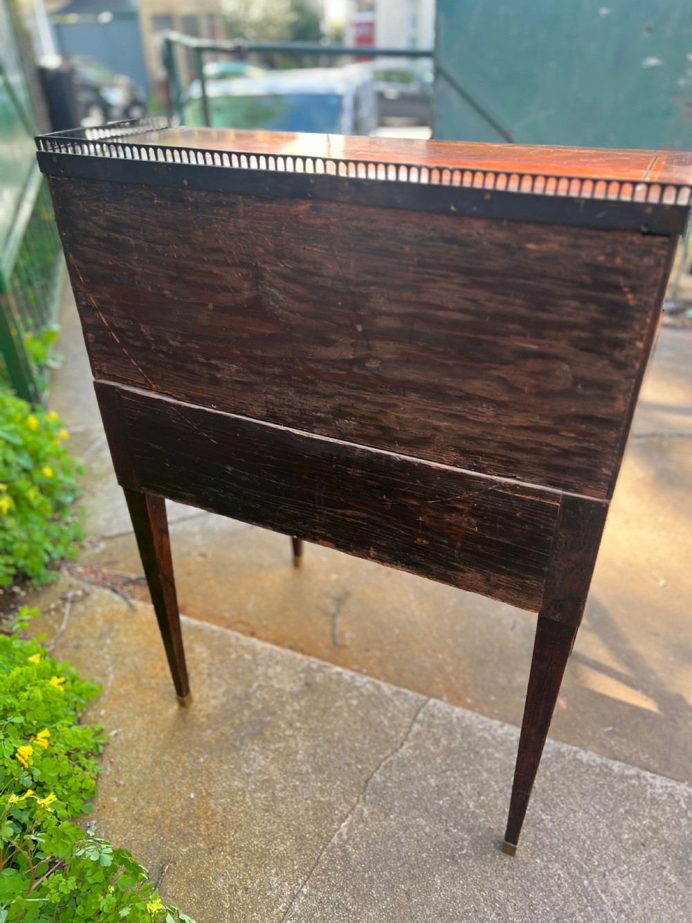 An 18th-century French bonheur de jour desk in warm brown inlaid wood, featuring square tapered legs, a single drawer with a tassel key, and a top cabinet with a pierced brass gallery. View VI