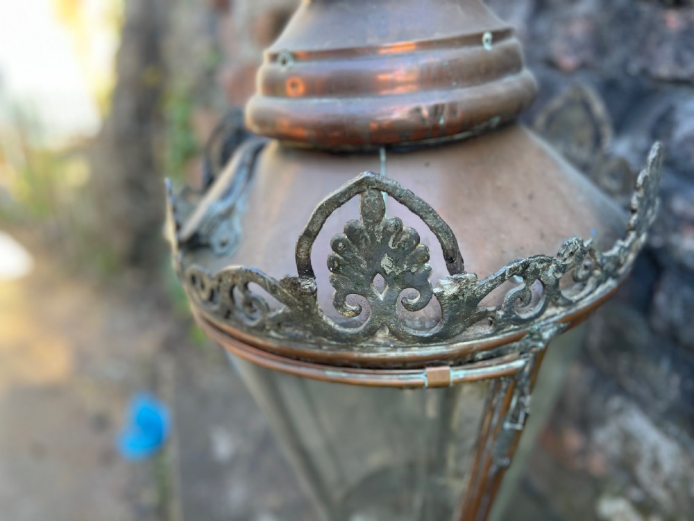 A large Edwardian copper and glass hanging lantern featuring decorative cresting and a top suspension loop. View VII