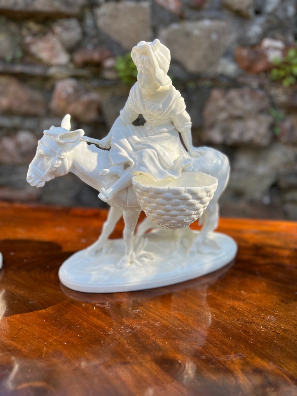 Pair of porcelain figures by moore bros, depicting a man and a woman riding donkeys  View II
