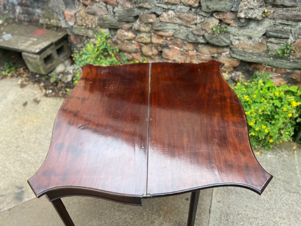 George III serpentine fronted mahogany tea table  View V