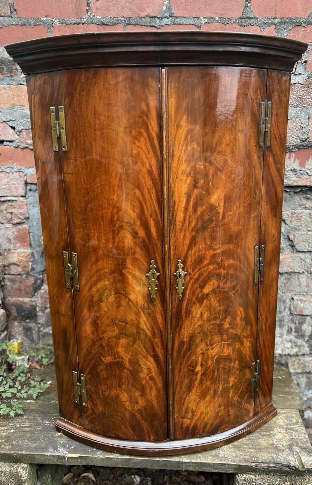 George III Flame mahogany bow fronted corner cupboard 