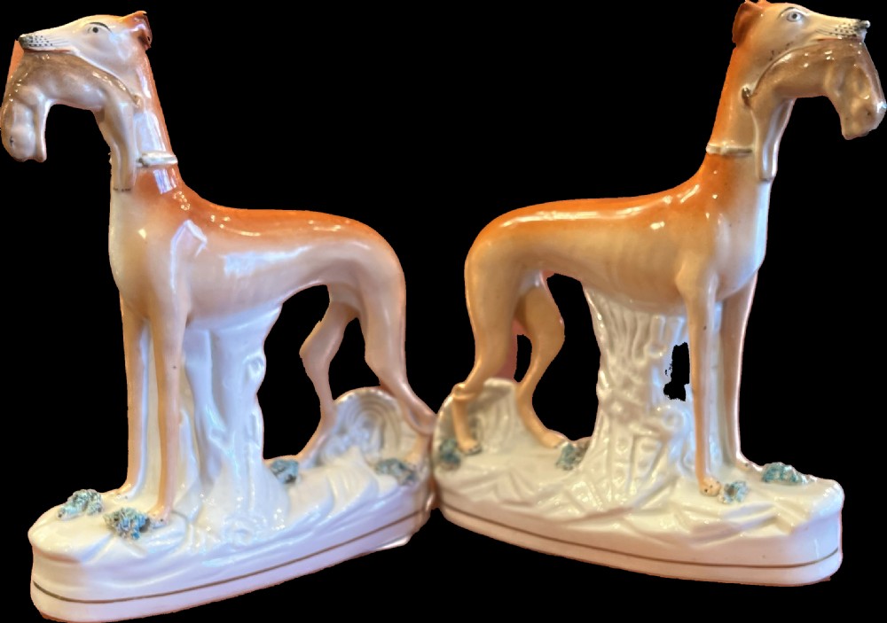 Pair of large Staffordshire greyhounds with hares in their  mouths  View II