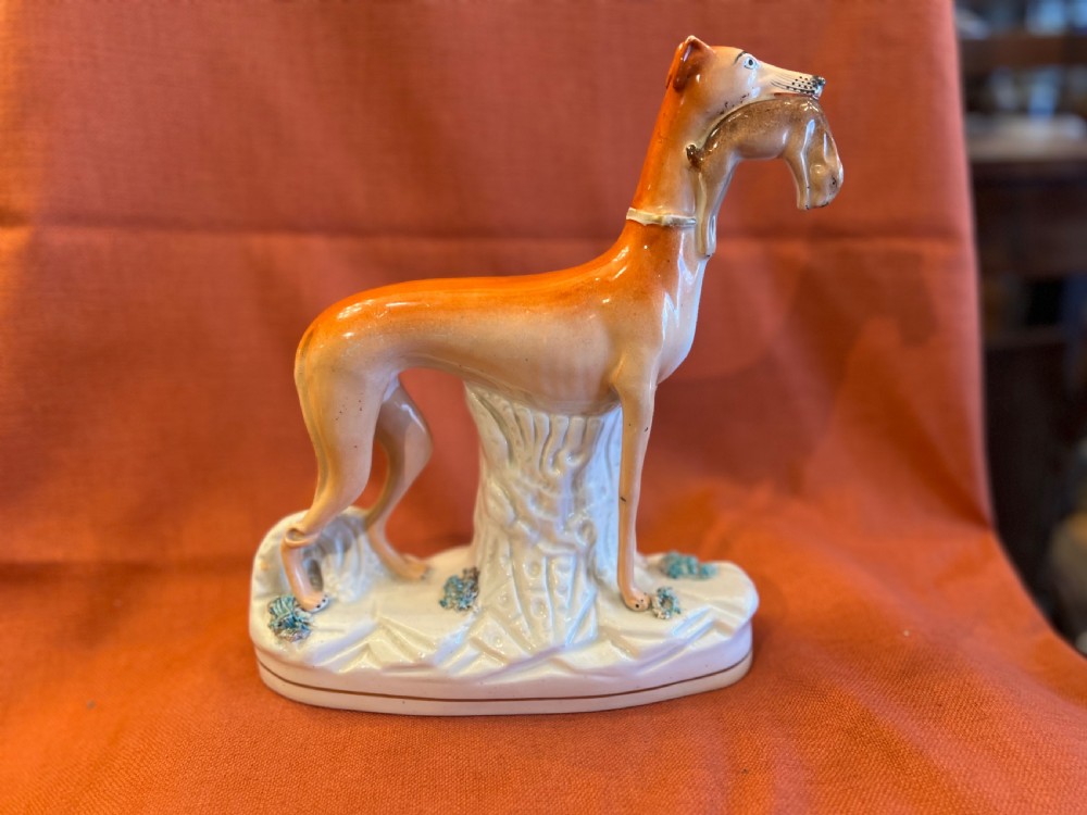 Pair of large Staffordshire greyhounds with hares in their  mouths  View III
