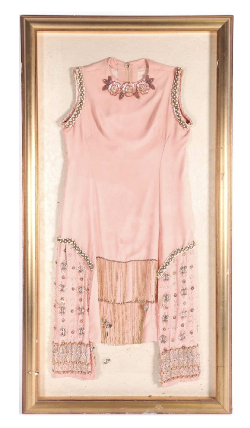 A 1920s salmon pink “Flapper dress” in a gilt frame 