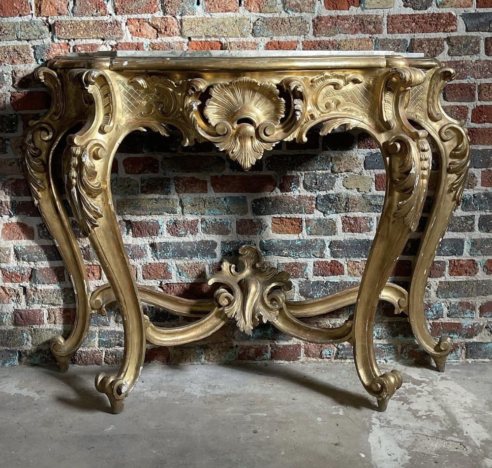 C18th carved and gilded console table with marble top in the rococo manner 