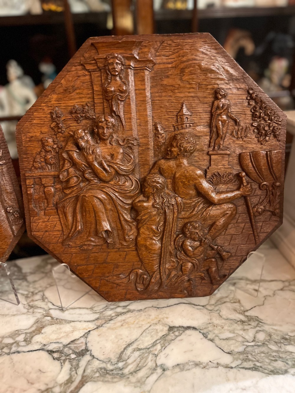 A pair of octagonal 18th-century carved oak relief plaques featuring classical mythological figures. View III