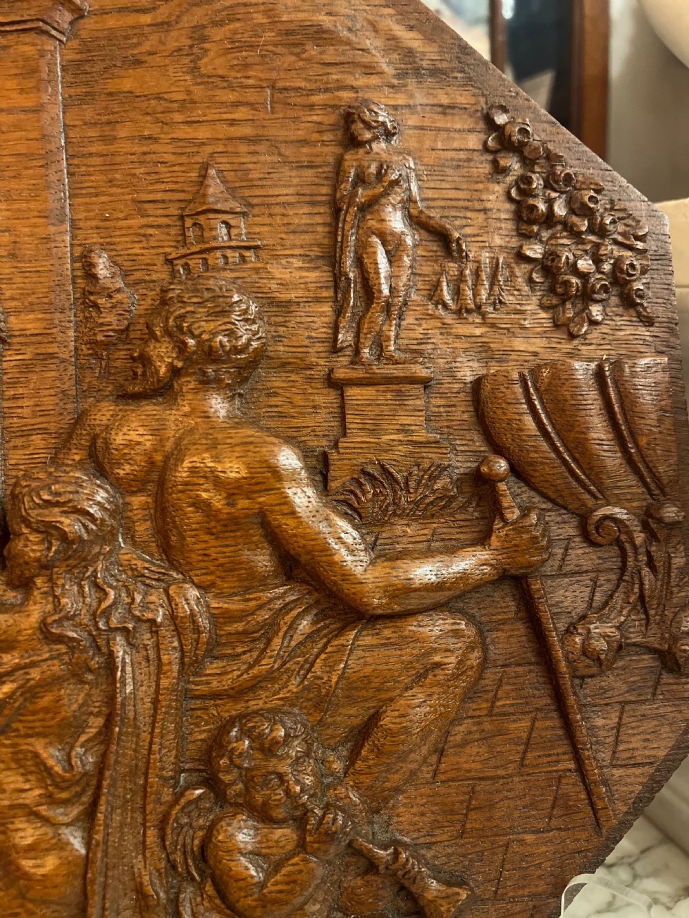 A pair of octagonal 18th-century carved oak relief plaques featuring classical mythological figures. View VII