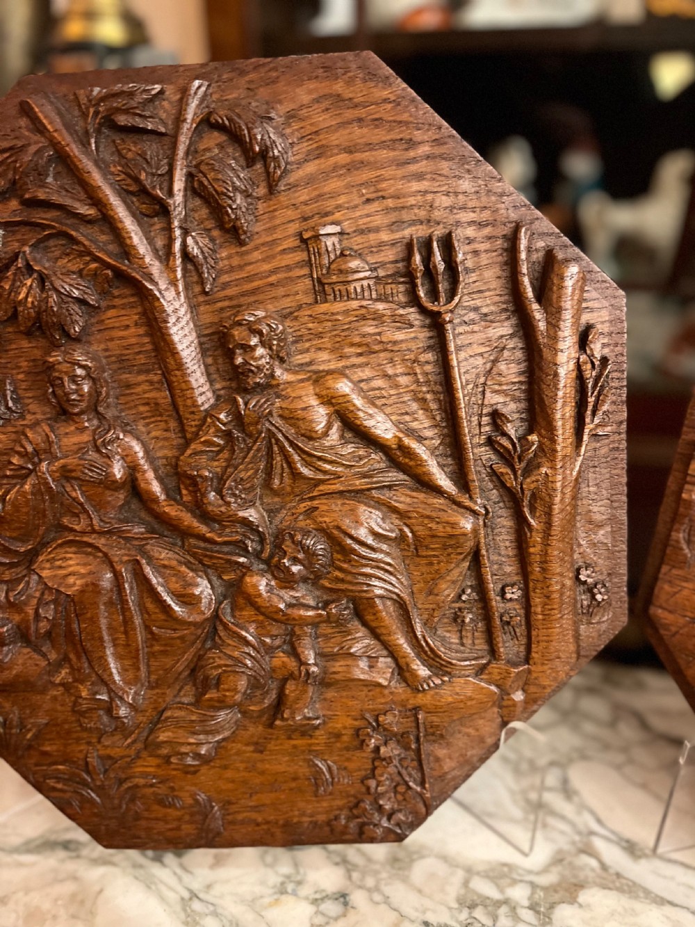 A pair of octagonal 18th-century carved oak relief plaques featuring classical mythological figures. View X
