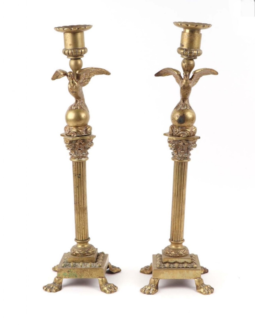 A pair of regency tall brass candlesticks 