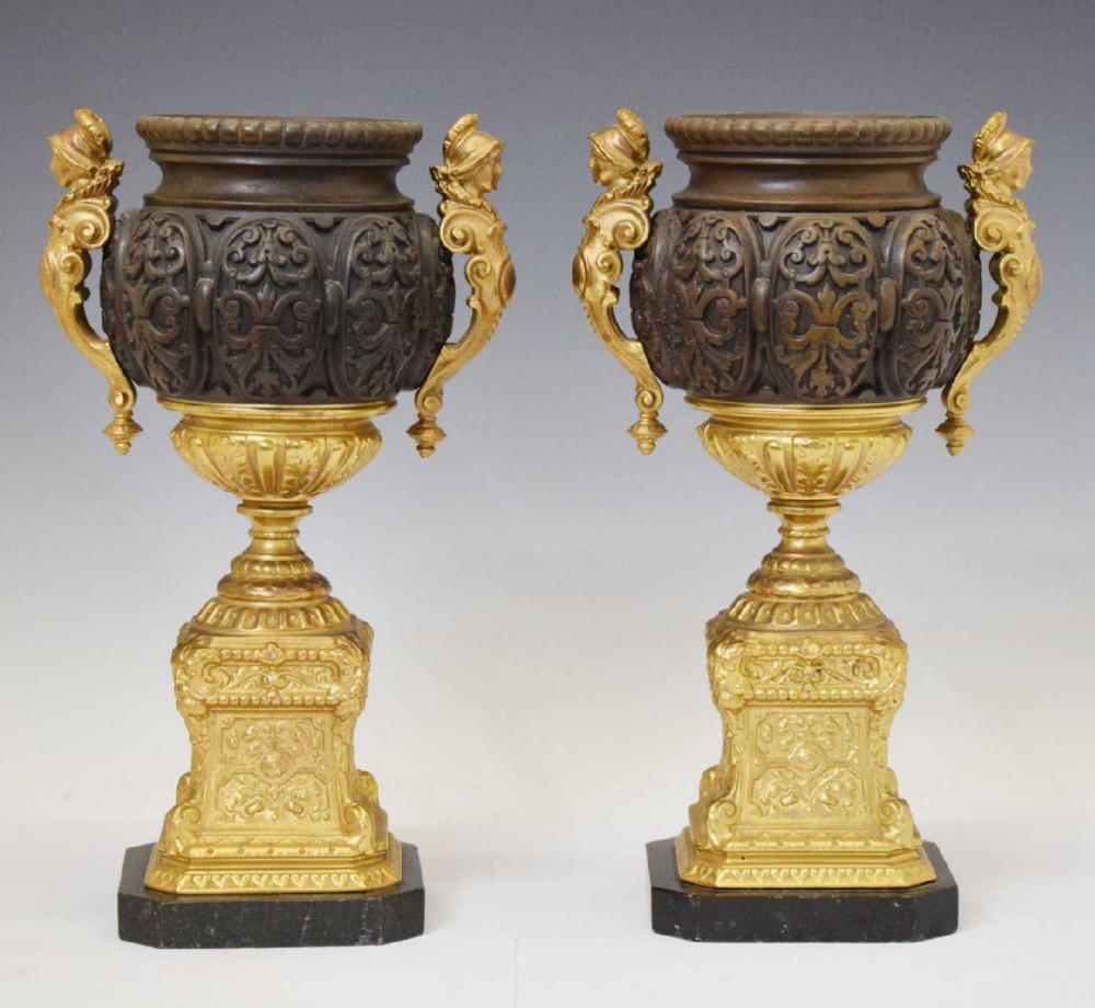 Pair of French bronzed and ormolu urns on pedestals 