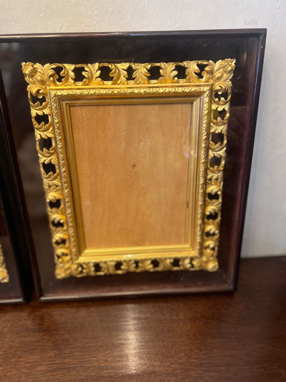Pair of C9th gilt picture frames in glass case  View III