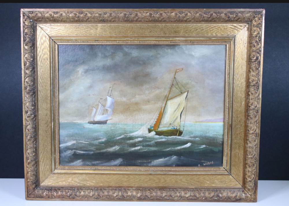 A framed oil painting on board depicting two sailing vessels on a choppy sea under cloudy skies.