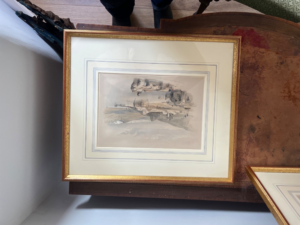 A pair of nineteenth-century tinted topographical prints depicting Middle Eastern architectural landscapes, displayed in gilt wood frames with multi-line cream mounts. View IV