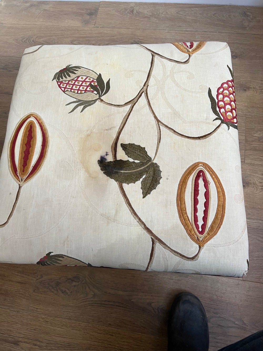 A 19th-century mahogany X-frame stool featuring carved scroll legs, a turned central stretcher, and a cream floral embroidered upholstered cushion. View VI