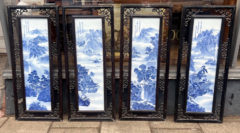 Set of four Chinese blue and white plaques in frames 