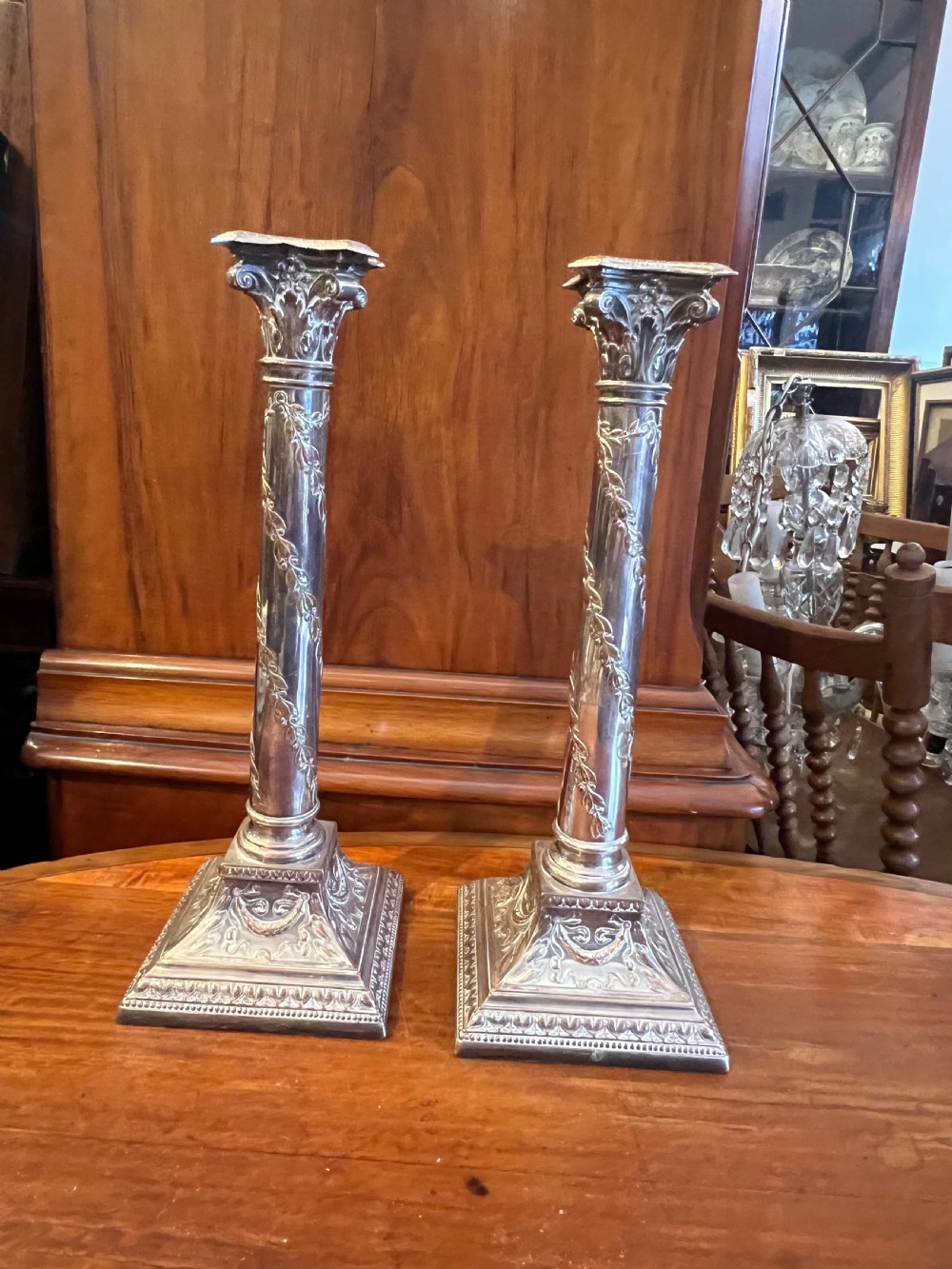 Pair of silver plate on copper Corinthian topped candlesticks  View II