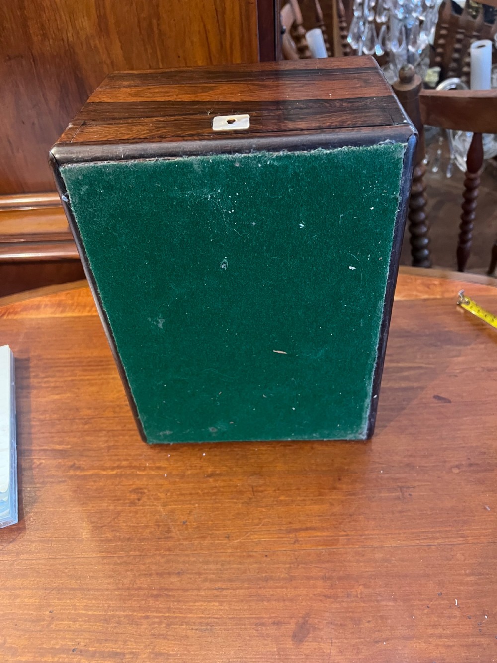 An open Victorian rosewood workbox featuring floral mother of pearl inlay, fitted green velvet interior, silver-toned vanity jars, glass bottles, and two small keys. View XX