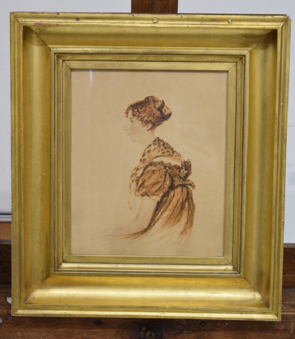 An early nineteenth-century watercolour portrait of a woman depicted in side profile, enclosed in a deep gilt moulded frame.