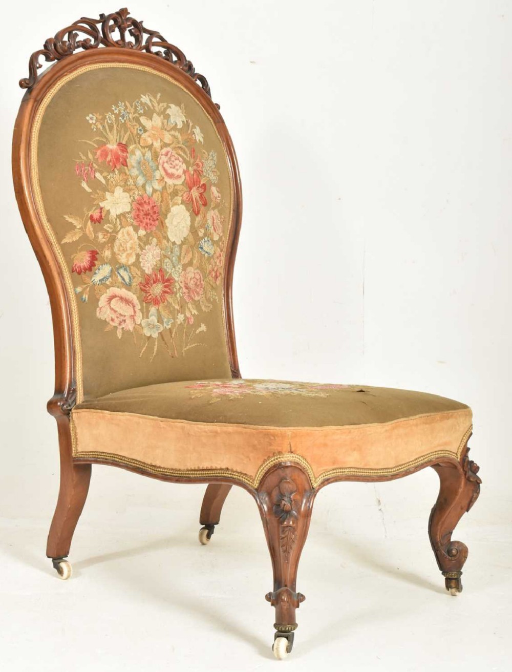 Large oversized chair in walnut and retaining its original embroidered fabric 