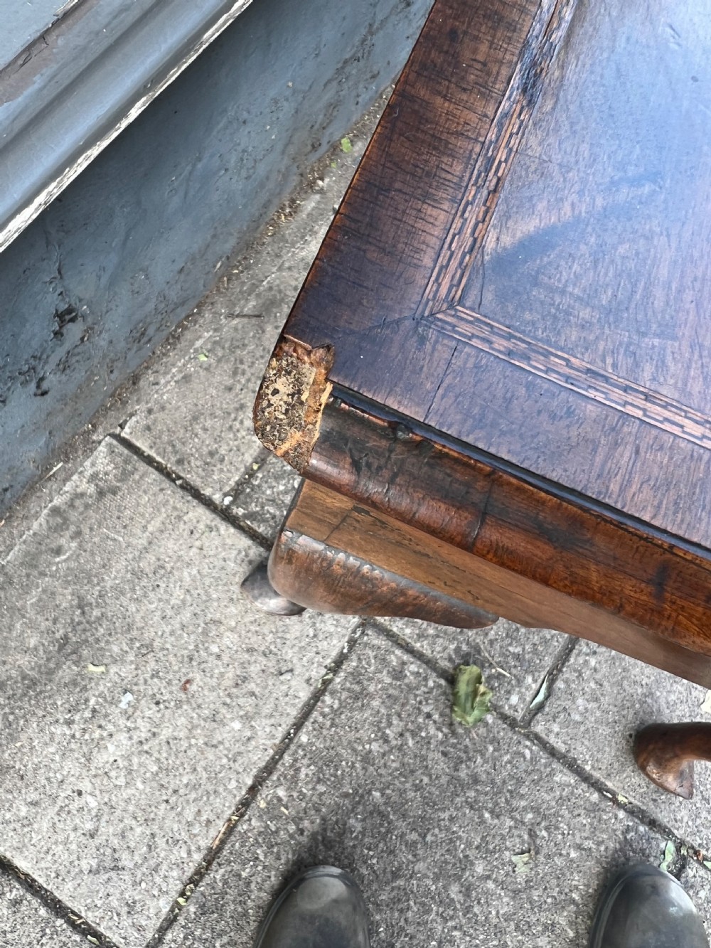 An early Georgian walnut side table with a single drawer, brass handles, shaped apron, and four cabriole legs. View VII
