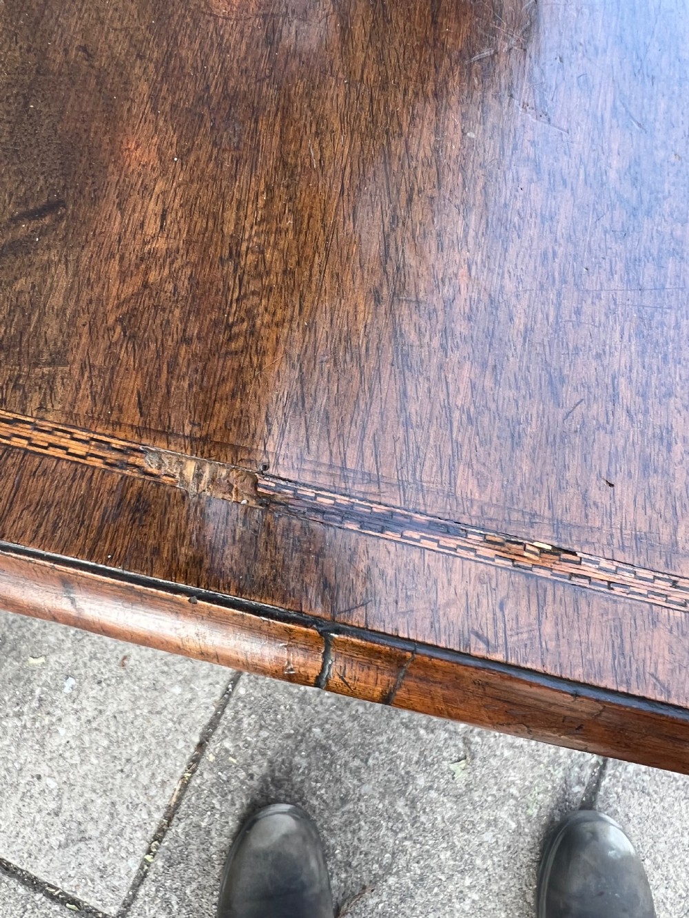 An early Georgian walnut side table with a single drawer, brass handles, shaped apron, and four cabriole legs. View VIII