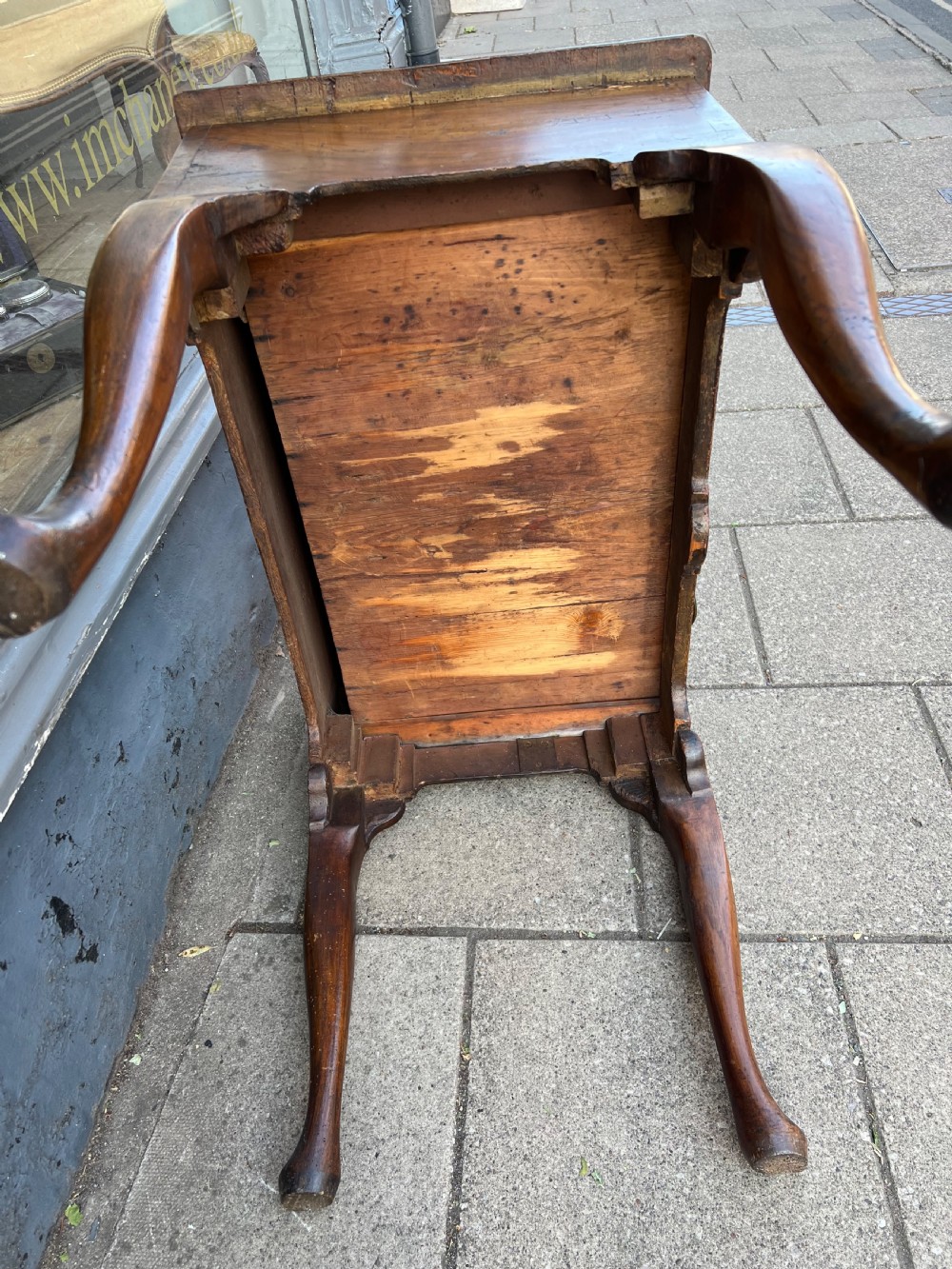An early Georgian walnut side table with a single drawer, brass handles, shaped apron, and four cabriole legs. View XI