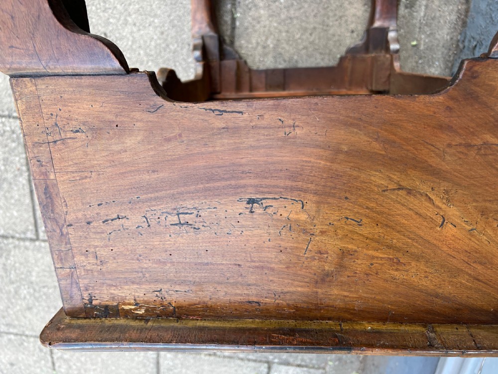 An early Georgian walnut side table with a single drawer, brass handles, shaped apron, and four cabriole legs. View XIII