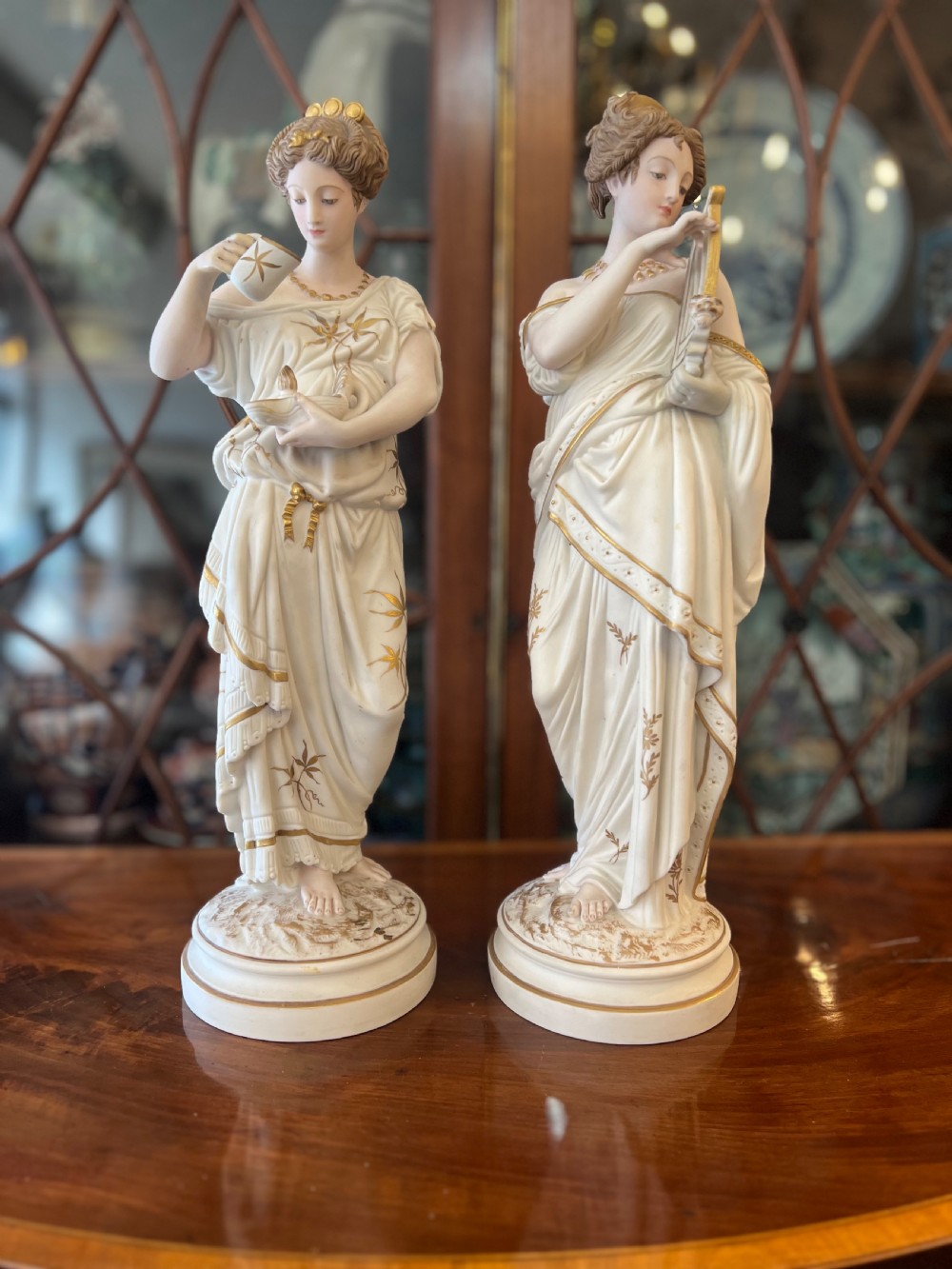 C19th bisque and gilded classical figures in the manner of Worcester 