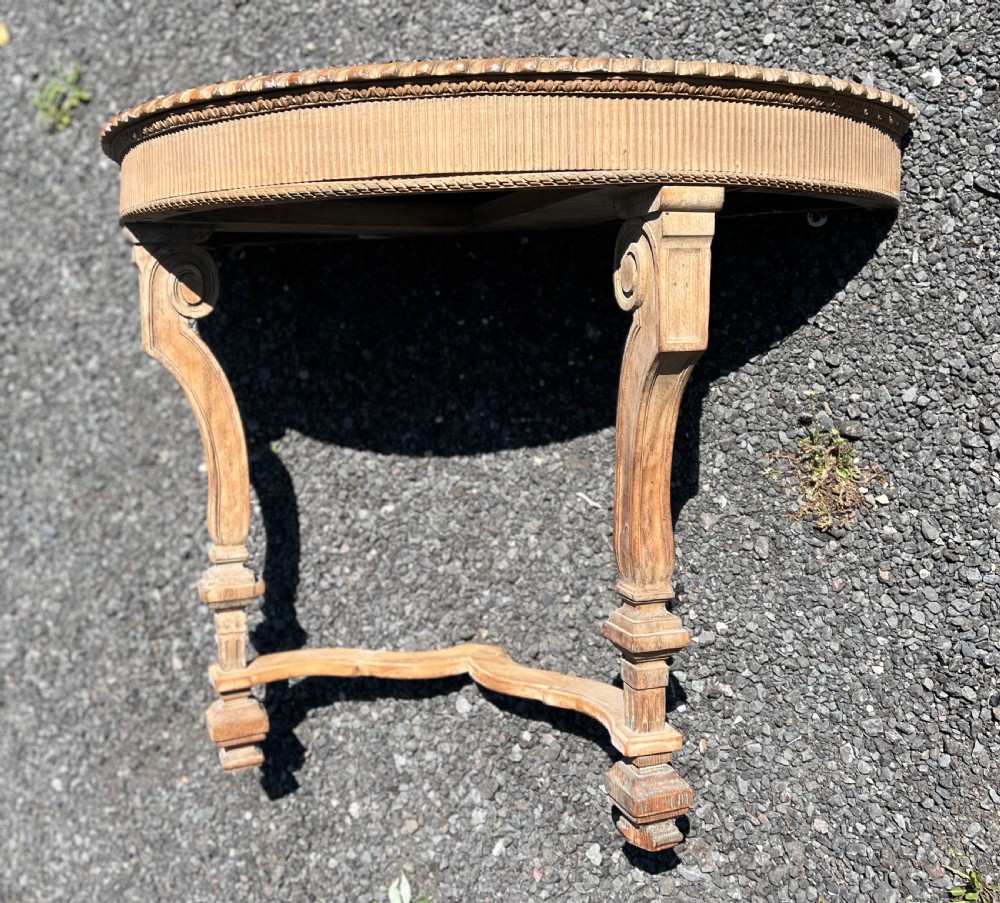 An overhead view of a semicircular carved oak console table featuring detailed fluting and scroll legs. View II