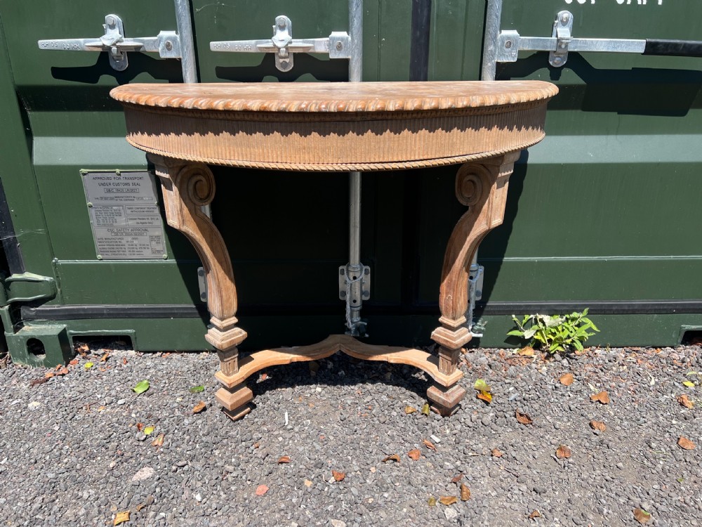 An overhead view of a semicircular carved oak console table featuring detailed fluting and scroll legs. View IV