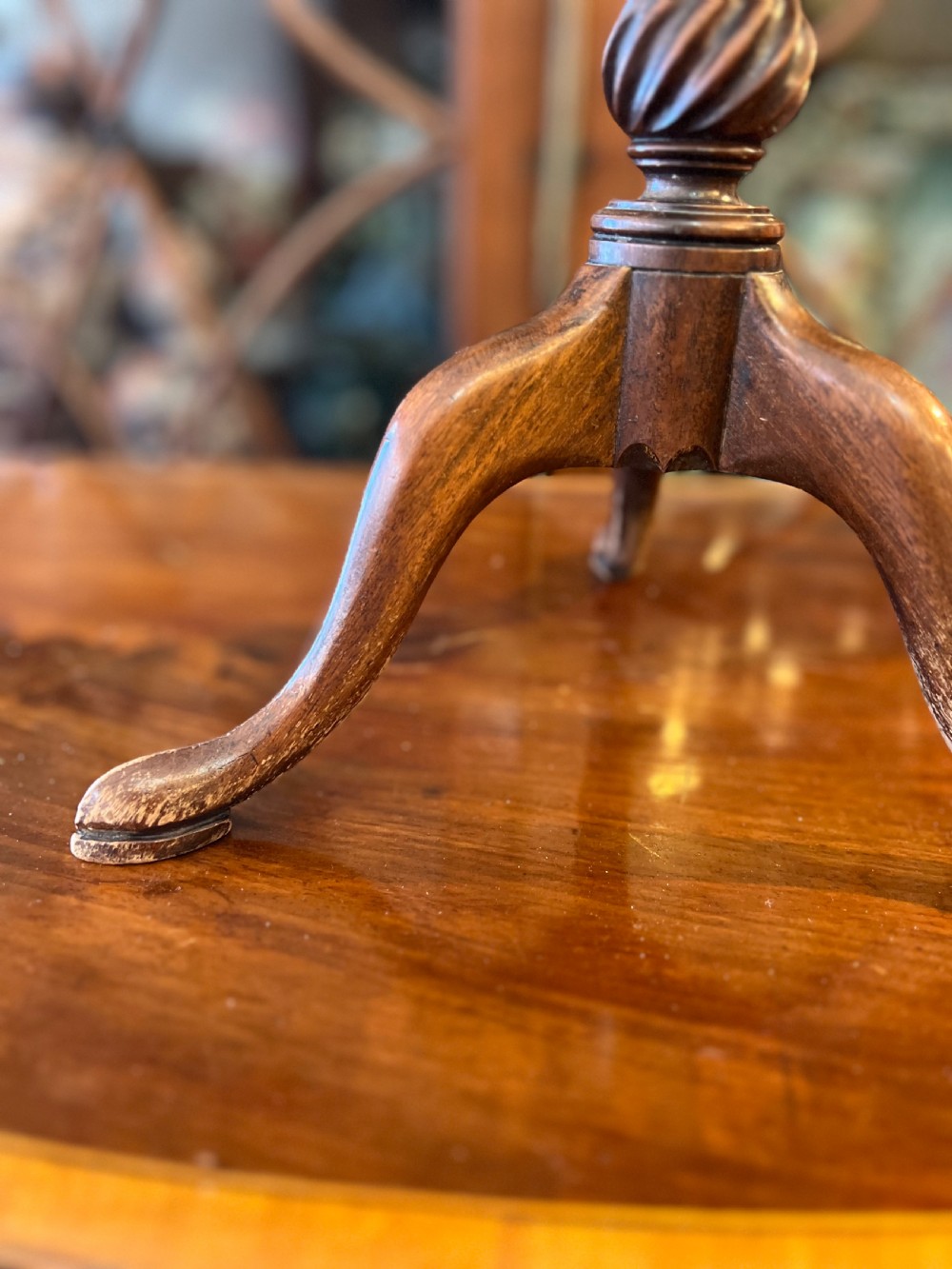 An early nineteenth-century turned wood treen plate stand featuring three spiral-carved upper arms above a turned central column and tripod base. View III