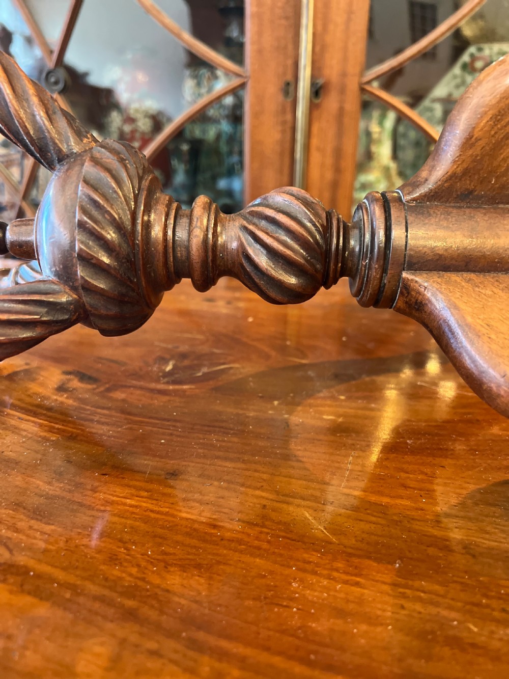 An early nineteenth-century turned wood treen plate stand featuring three spiral-carved upper arms above a turned central column and tripod base. View VI