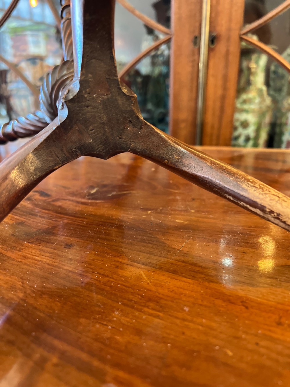 An early nineteenth-century turned wood treen plate stand featuring three spiral-carved upper arms above a turned central column and tripod base. View VIII